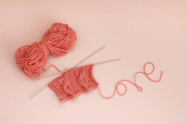 knitting with a skein of thread and the word love