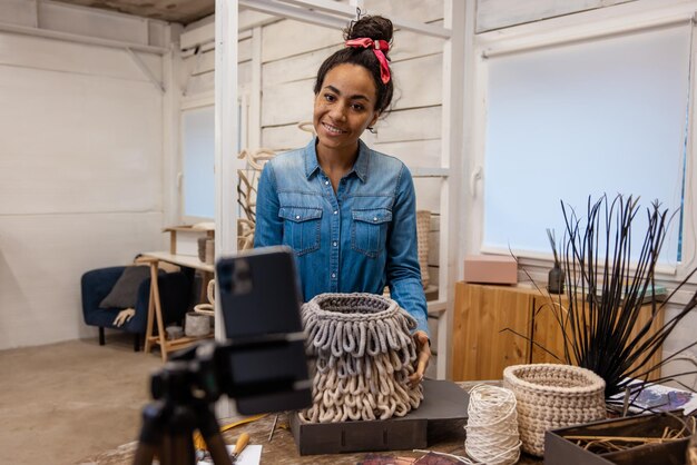 Photo knitting workshop online. dark-haired young woman explaining how to knit the bag