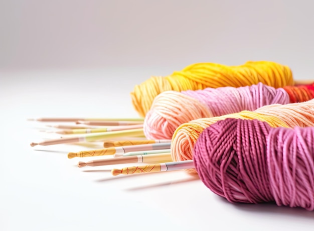 Knitting yarn balls and needles on a white background