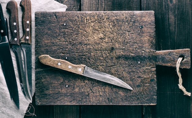 Photo knives and brown wooden cutting board