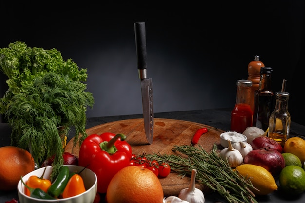 Knives on a wooden board .composition of various products for cooking. Top view.