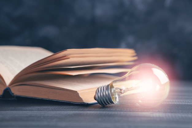 Knowledge and wisdom, light bulb on the book