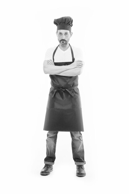 Known for his cooking Bearded mature man in chef hat and apron Senior cook with beard and moustache wearing bib apron Mature chief cook in red cooking apron Home cooking