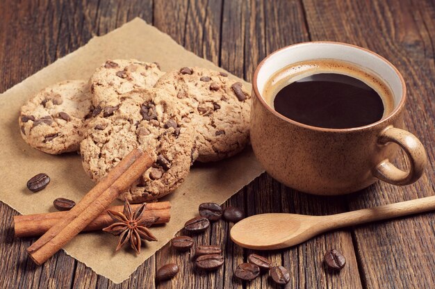 Foto koekjes met chocolade en kopje koffie op donkere houten tafel