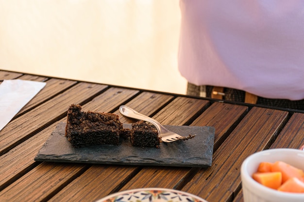 Koekjescake op een leisteen naast een vork.