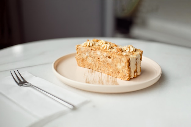 Koffie cake. Een fluitje van een cent op een bord. Zoet dessert op een rond roze met een bord