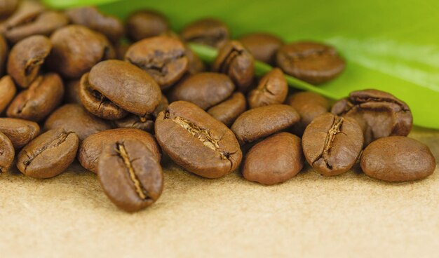 Koffiebonen en blad op oude houten tafel