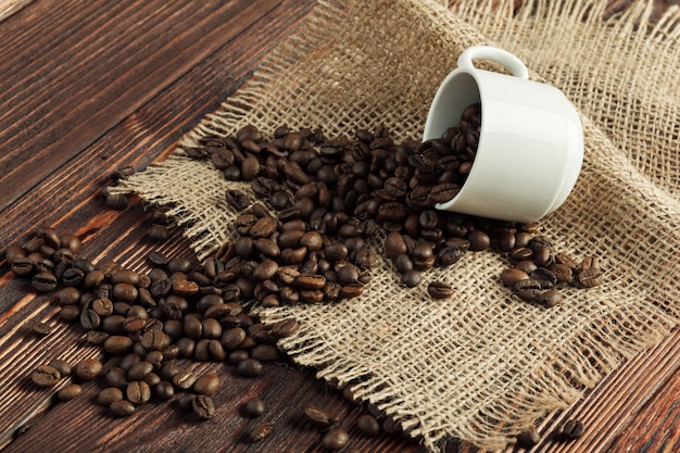 Koffiekop en koffiebonen op houten achtergrond