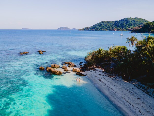 Koh Wai Island Thailand tropical Island near Koh Chang couple of men and woman on the beach