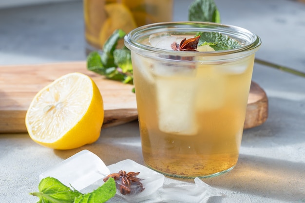 Kombucha or cider fermented drink in glass with anise ice. Heathy probiotic drink