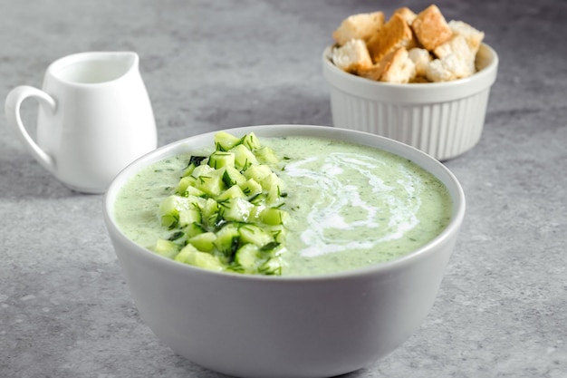 Komkommer Gazpacho Groene verse koude zomersoep op grijze achtergrond concept van veganistische keuken