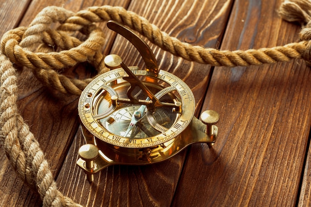 Kompas en touw op houten tafel. detailopname