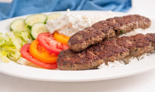 Koobideh ground lamb with rice and vegetables,
