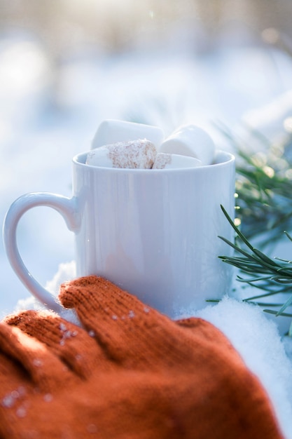 Kopje koffie met marshmallow in sneeuw