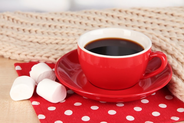 Kopje koffie met sjaal op tafel in de kamer