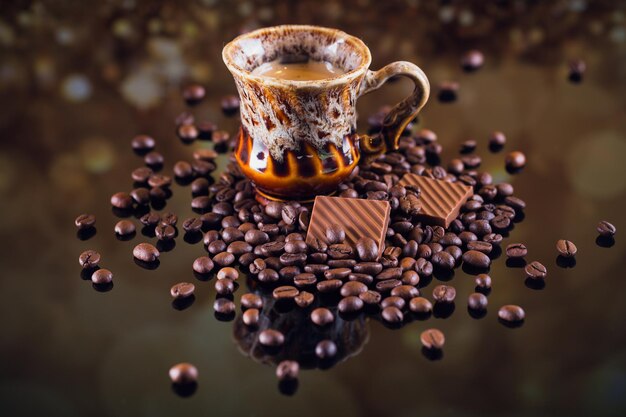 Kopje koffie op hoop gebrande koffiebonen. Mooie koffie achtergrond.