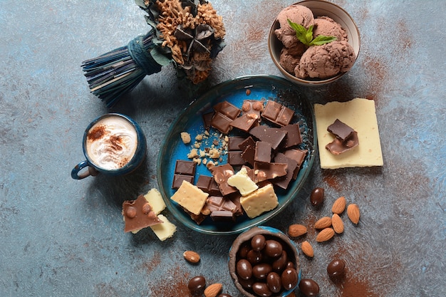 Kopje koffie, zwarte en witte chocolade, amandelnoten.