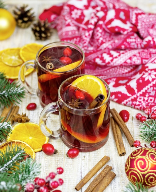 Kopjes met warme glühwein op een houten ondergrond. Nieuwjaarsconcept