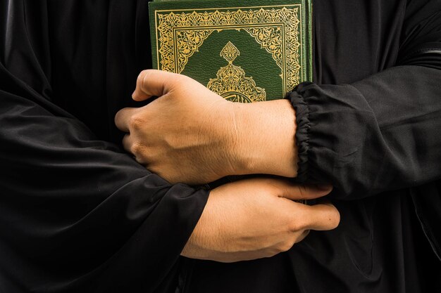 Koran in hand holy book of muslims public item of all muslims koran in hand muslims woman