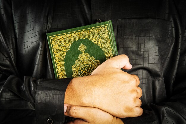 Коран в руках священная книга мусульман общественный предмет всех мусульман