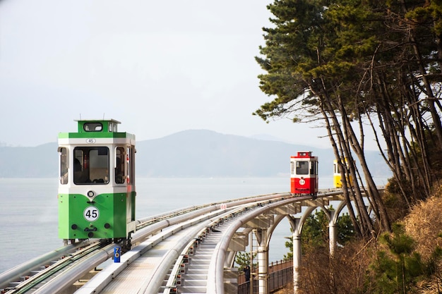 Koreaanse mensen en buitenlandse reizigers zittende passagiers reizen op Sky Capsule Tram Haeundae Blue Line op Mipo Station voor reisbezoek in Haeundae Beach Park in de stad Haeundae gu in Busan, Zuid-Korea