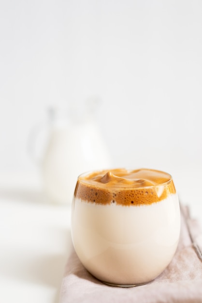 Korean Coffee Dalgona. Iced fluffy creamy whipped trend coffee drink with coffee foam and milk