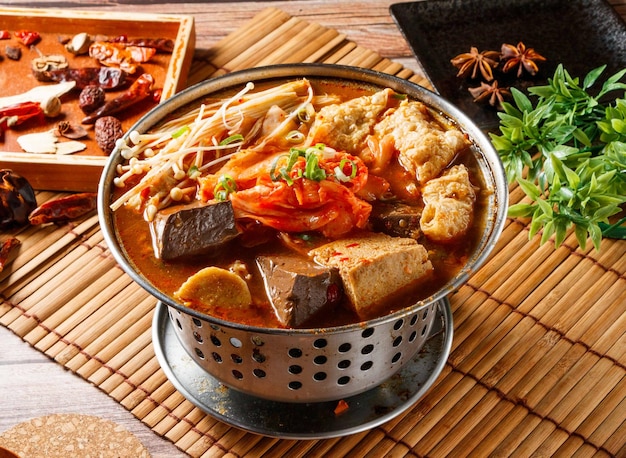 Korean Duck Blood hot Pot stew with red chili isolated on mat side view of japanese food