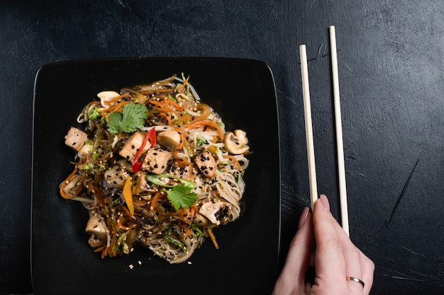 Korean food eating culture. woman using chopsticks as traditional flatware