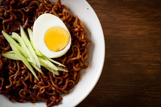 Korean Instant Noodle with Black Bean Sauce topped cucumber and boiled egg (Jajangmyeon or JJajangmyeon) - Korean food style