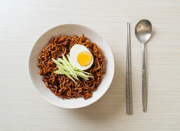 Korean Instant Noodle with Black Bean Sauce topped cucumber and boiled egg (Jajangmyeon or JJajangmyeon) - Korean food style