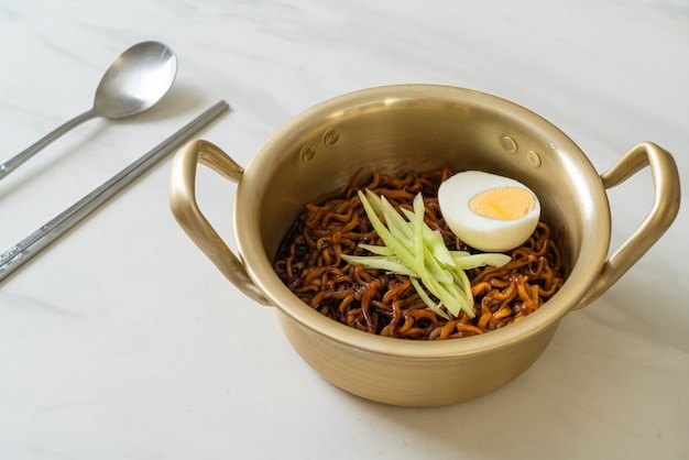 Korean Instant Noodle with Black Bean Sauce topped cucumber and boiled egg (Jajangmyeon or JJajangmyeon) - Korean food style