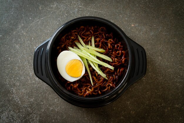 Korean Instant Noodle with Black Bean Sauce topped cucumber and boiled egg (Jajangmyeon or JJajangmyeon) - Korean food style