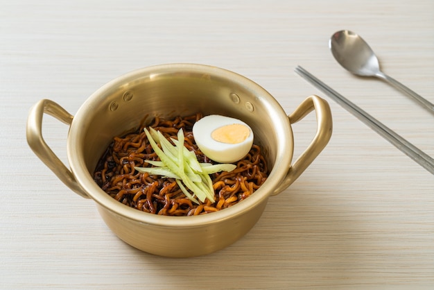 Korean Instant Noodle with Black Bean Sauce topped cucumber and boiled egg (Jajangmyeon or JJajangmyeon) - Korean food style