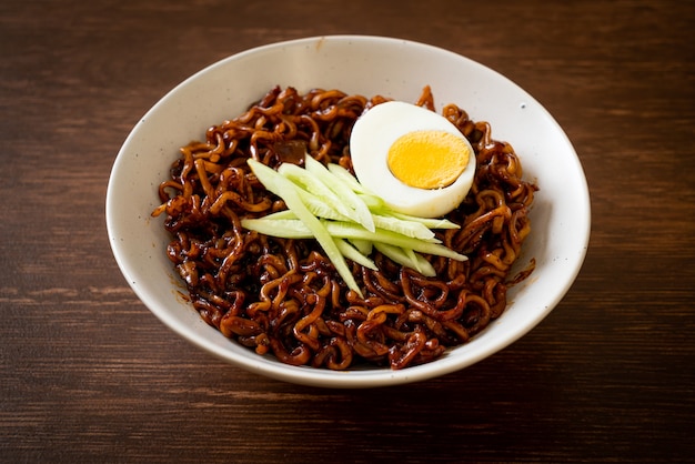 Korean Instant Noodle with Black Bean Sauce topped cucumber and boiled egg (Jajangmyeon or JJajangmyeon) - Korean food style