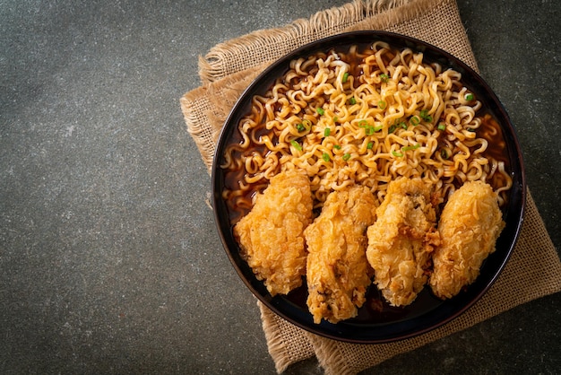 Korean instant noodles with fried chicken or Fried chicken ramyeon - Korean food style