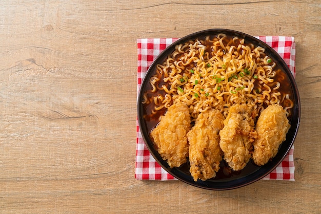 Korean instant noodles with fried chicken or Fried chicken ramyeon - Korean food style