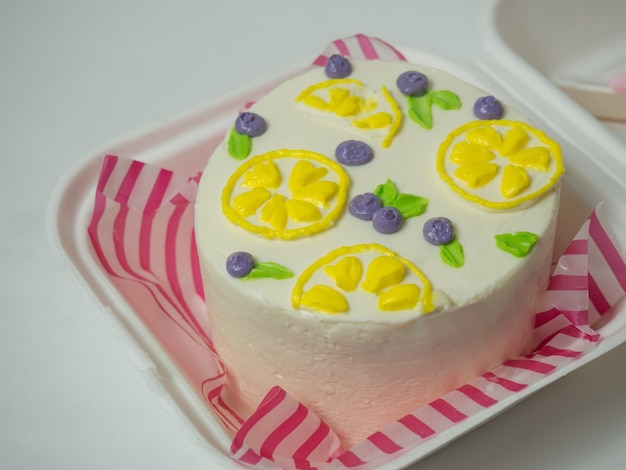 Korean lunch box cake with cream flowers and berries. place for your text