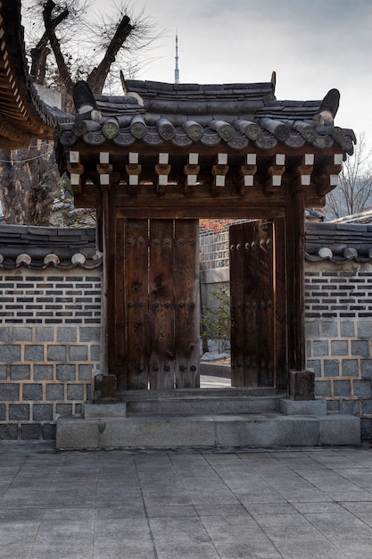 Korean pagoda gate, open door, park entrance. Vertical.