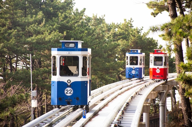 Korean people and foreign travelers sitting passengers journey on Sky Capsule Tram Haeundae Blue Line at Mipo Station for travel visit in Haeundae Beach Park at Haeundae gu city in Busan South Korea