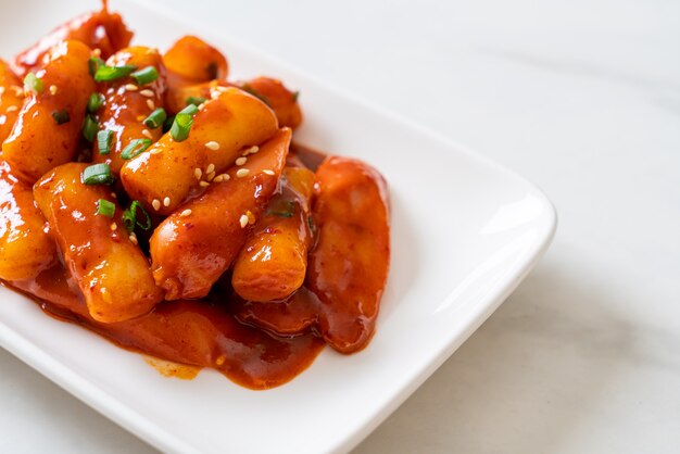 Korean rice cake stick with sausage in spicy sauce (Tteokbokki) - Korean food style