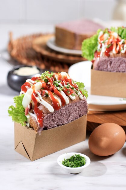 Korean Sandwich Purple Bread (Egg Drop) with Egg, Lettuce, Mayonaise, Cheese, Parsley, Sauce. Served with Milk. White Background Concept for Bakery or Advertisement