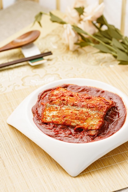 Korean style braised hairtail on a simple background