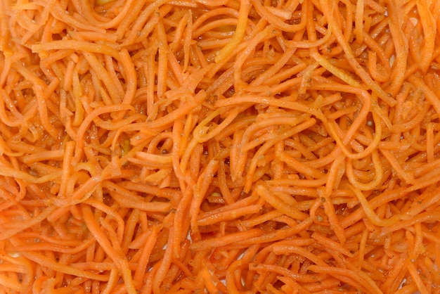 Korean-style carrots, grated carrots as a background.