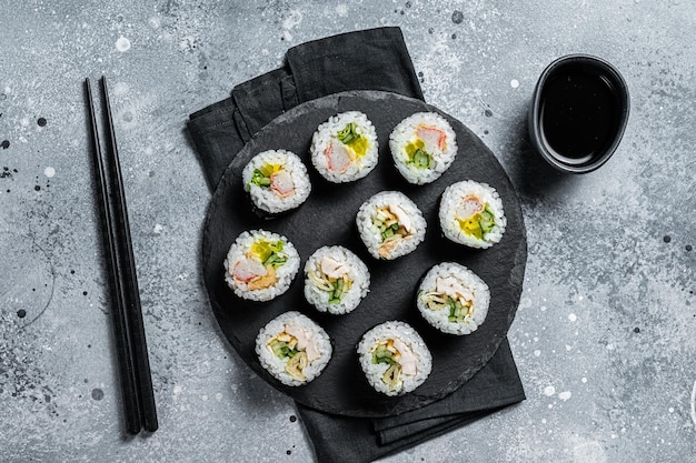 Korean style sushi Kimbap or gimbap made from steamed white rice Gray background Top view