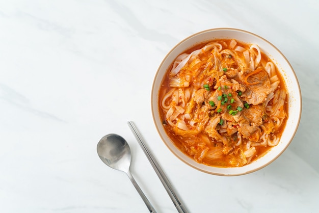 Korean udon ramen noodles with pork in kimchi soup