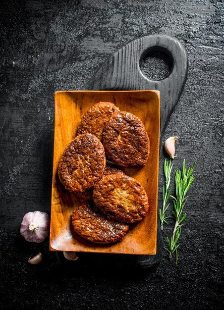 Koteletten op een bord met rozemarijn en knoflook