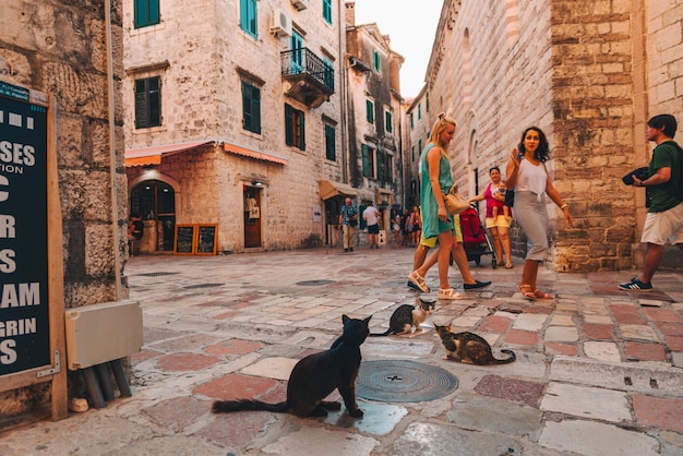 KOTOR, MONTENEGRO - July 19, 1990: tourists walking by tight kotor streets. summer vacation