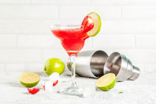 Koude aardbei Margarita cocktail met ijs, limoen en verse bessen