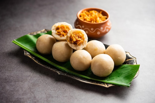 Photo kozhukatta or kolukattai pidi is steamed dumplings made with rice flour filling coconut jaggery