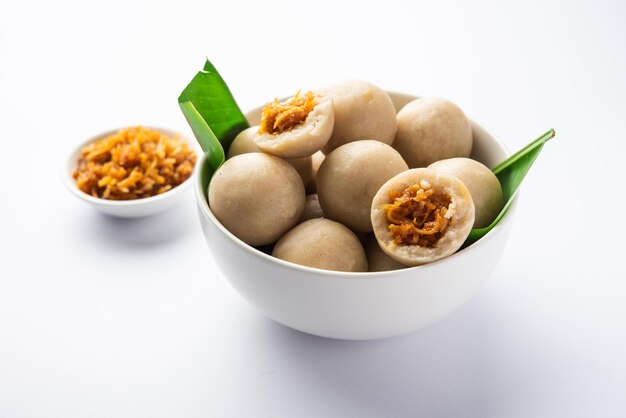 Photo kozhukatta or kolukattai pidi is steamed dumplings made with rice flour filling coconut jaggery